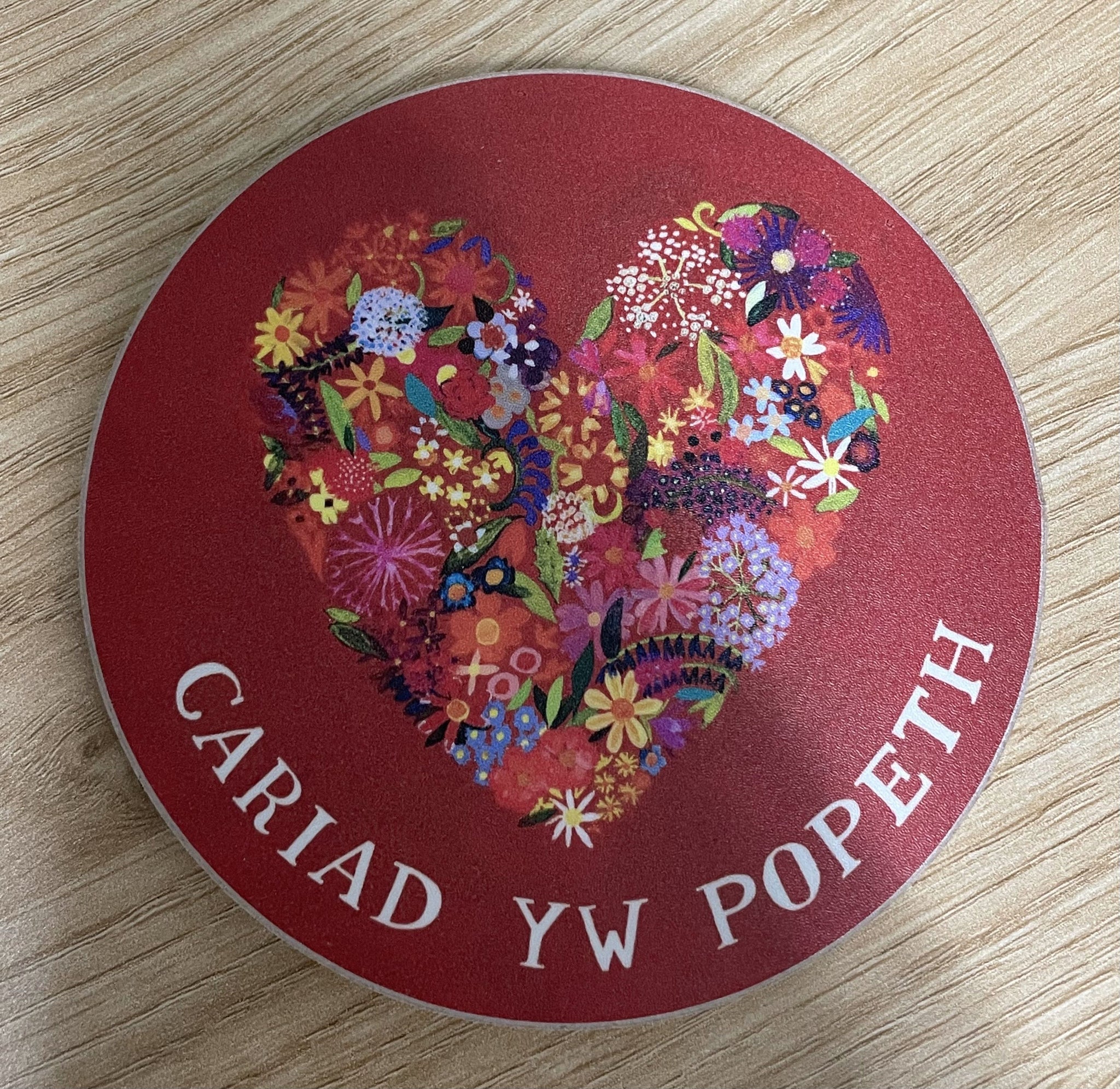 'Cariad yw Popeth' round coaster by Lizzie Spikes